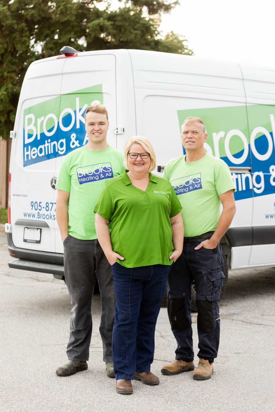 Nathalie, Chris, and Lucas Brooks in front of a Brooks Heating & Air van