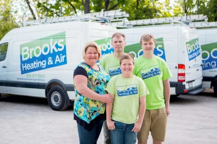 Nathalie, Chris and the boys with the Brooks Heating & Air fleet