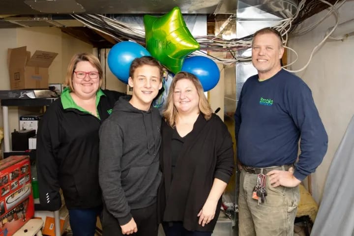 The Brooks team installing a free furnace for a contest winner