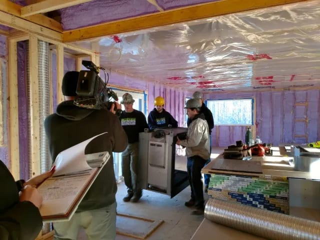 Brooks Heating and Air technicians staging new equipment on AC replacement day at a Halton Hills jobsite