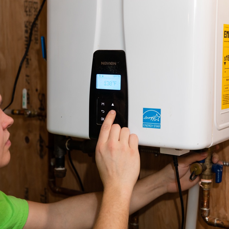 Brooks Heating & Air technician servicing a tankless water heater