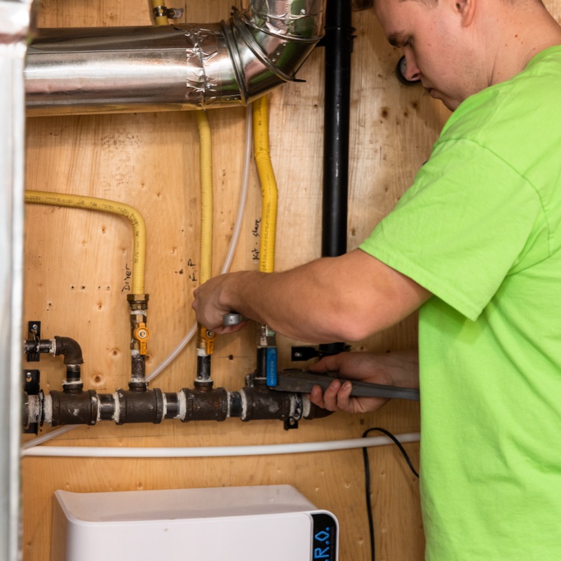 Brooks technician repairing hydronic heating lines