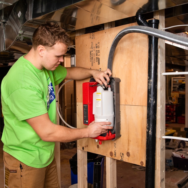 Brooks technician wiring an HVAC control board